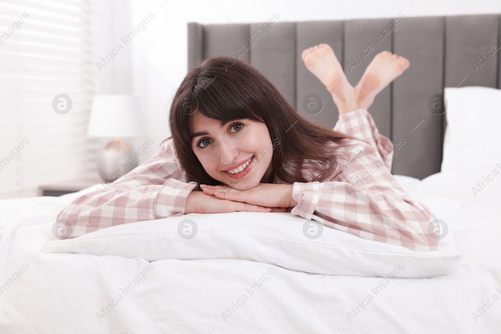 Beautiful woman lying on bed at home Photo of Beautiful woman lying on bed at home