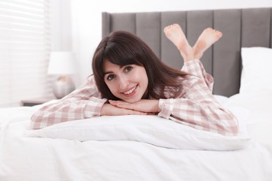 Photo of Beautiful woman lying on bed at home