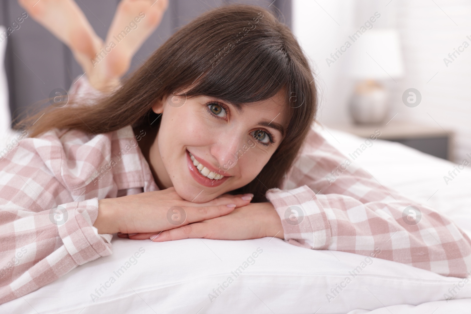 Beautiful woman lying on bed at home Photo of Beautiful woman lying on bed at home