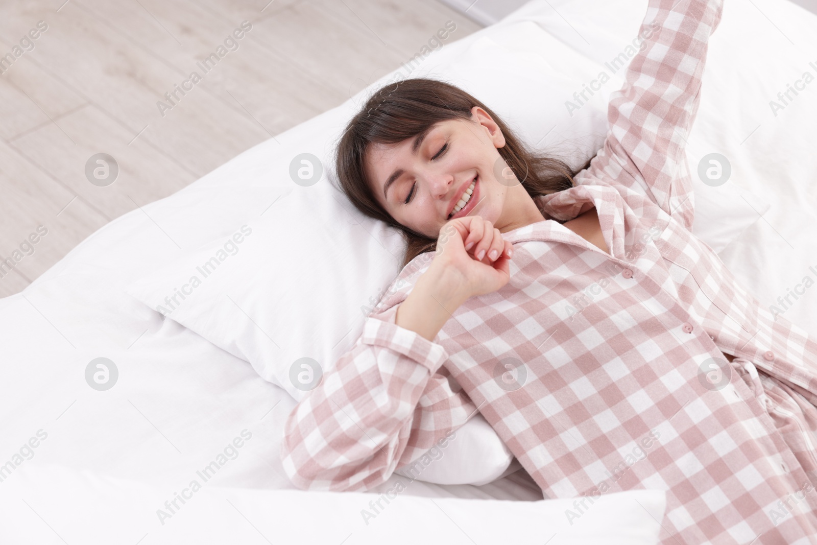 Beautiful woman awaking in comfortable bed at home Photo of Beautiful woman awaking in comfortable bed at home