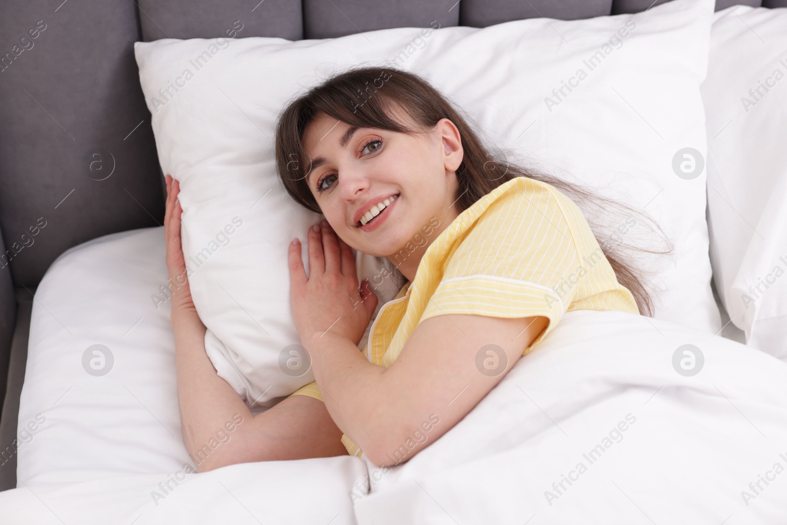 Beautiful woman lying on bed at home Photo of Beautiful woman lying on bed at home