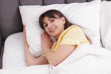 Photo of Beautiful woman lying on bed at home