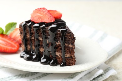Photo of Piece of chocolate cake served with strawberries on table, closeup