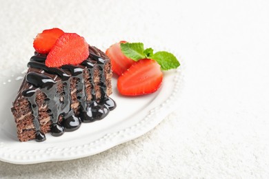 Photo of Piece of chocolate cake served with strawberries on white table, closeup. Space for text