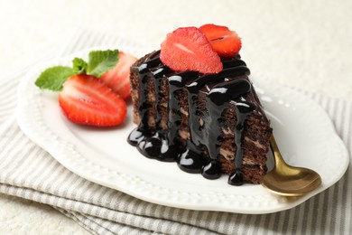 Photo of Piece of chocolate cake served with strawberries on white table, closeup