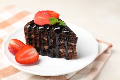 Photo of Piece of chocolate cake served with strawberries on white table, closeup