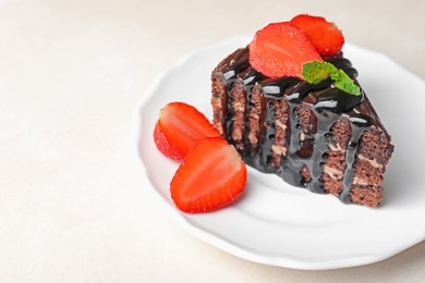 Photo of Piece of chocolate cake served with strawberries on white table, closeup. Space for text