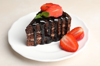 Photo of Piece of chocolate cake served with strawberries on white table, closeup