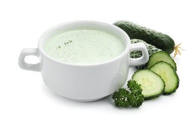 Photo of Tasty cucumber soup and fresh vegetables isolated on white
