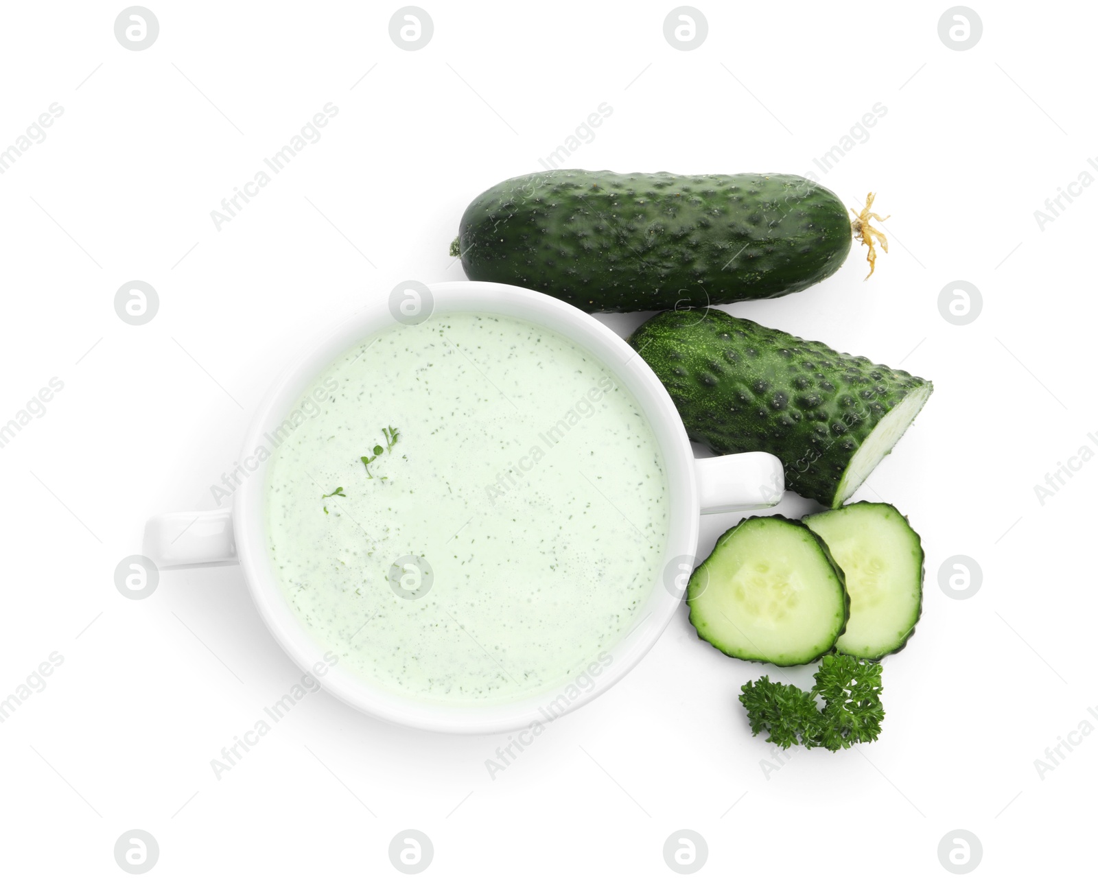 Photo of Tasty cucumber soup and fresh vegetables isolated on white, top view