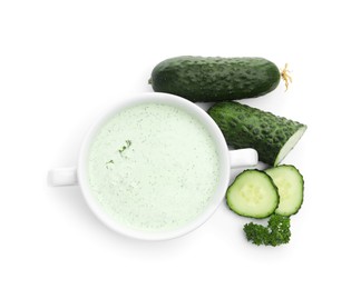 Photo of Tasty cucumber soup and fresh vegetables isolated on white, top view
