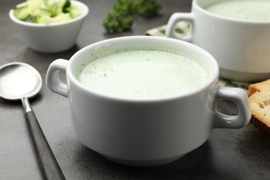 Photo of Tasty cucumber soup served on grey table, closeup