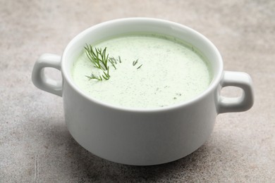 Photo of Tasty cucumber soup with dill on grey table, closeup