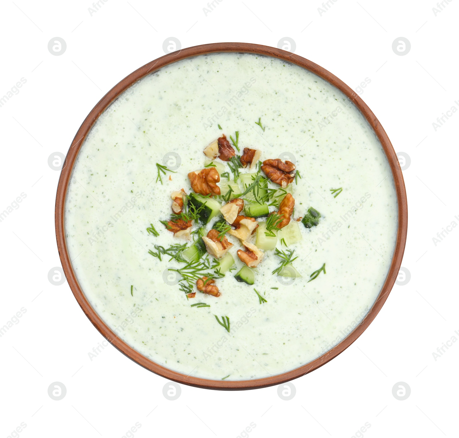 Photo of Tasty cucumber soup with dill and walnuts isolated on white, top view
