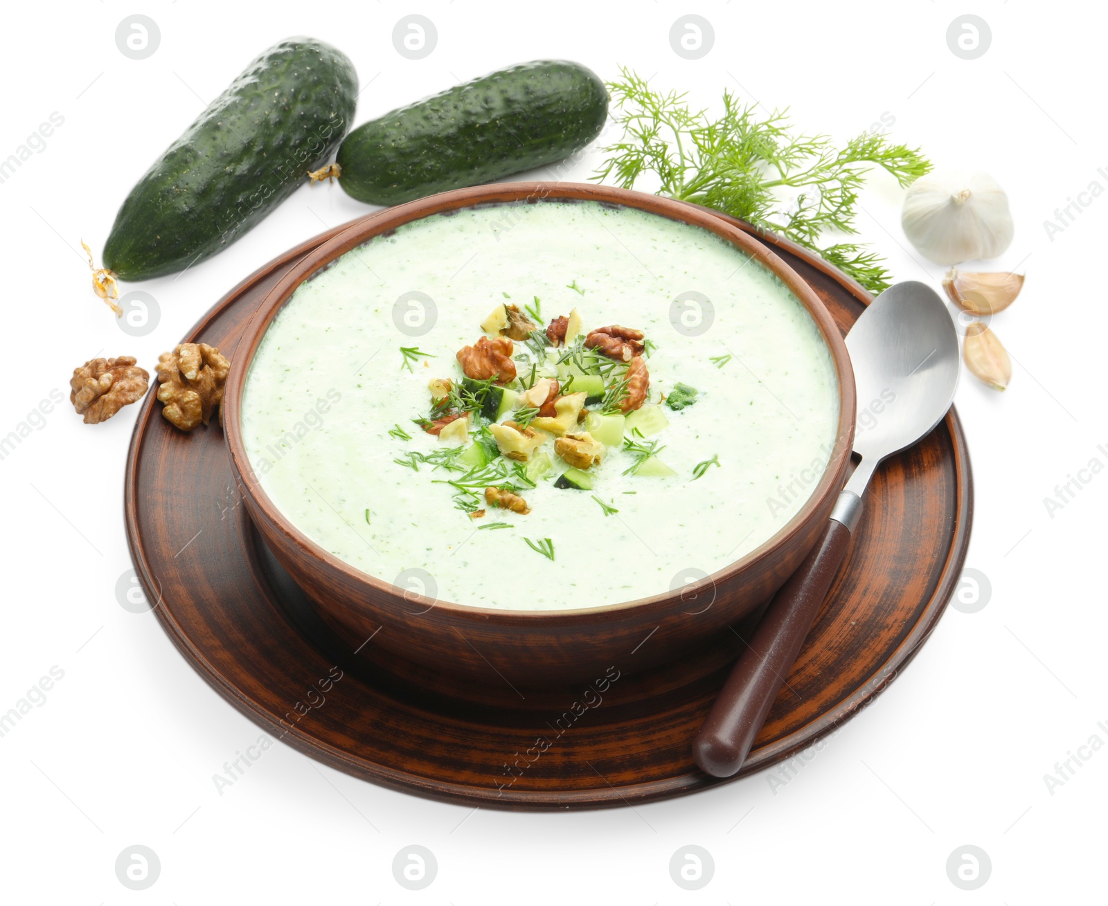 Photo of Tasty cucumber soup with dill, walnuts and ingredients isolated on white