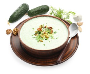 Photo of Tasty cucumber soup with dill, walnuts and ingredients isolated on white