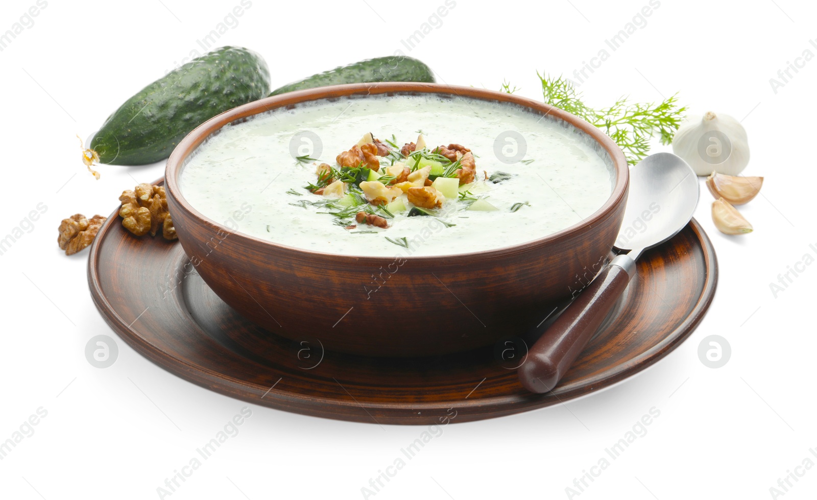 Photo of Tasty cucumber soup with dill, walnuts and ingredients isolated on white