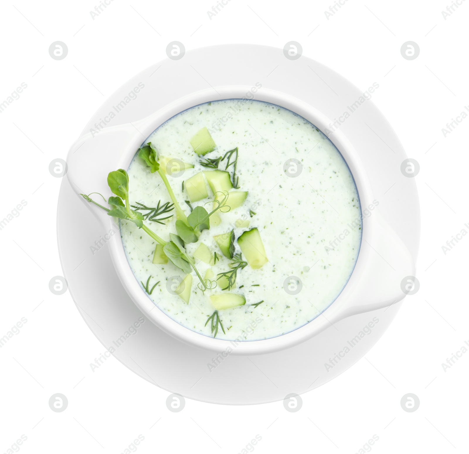 Photo of Tasty cucumber soup with microgreens isolated on white, top view