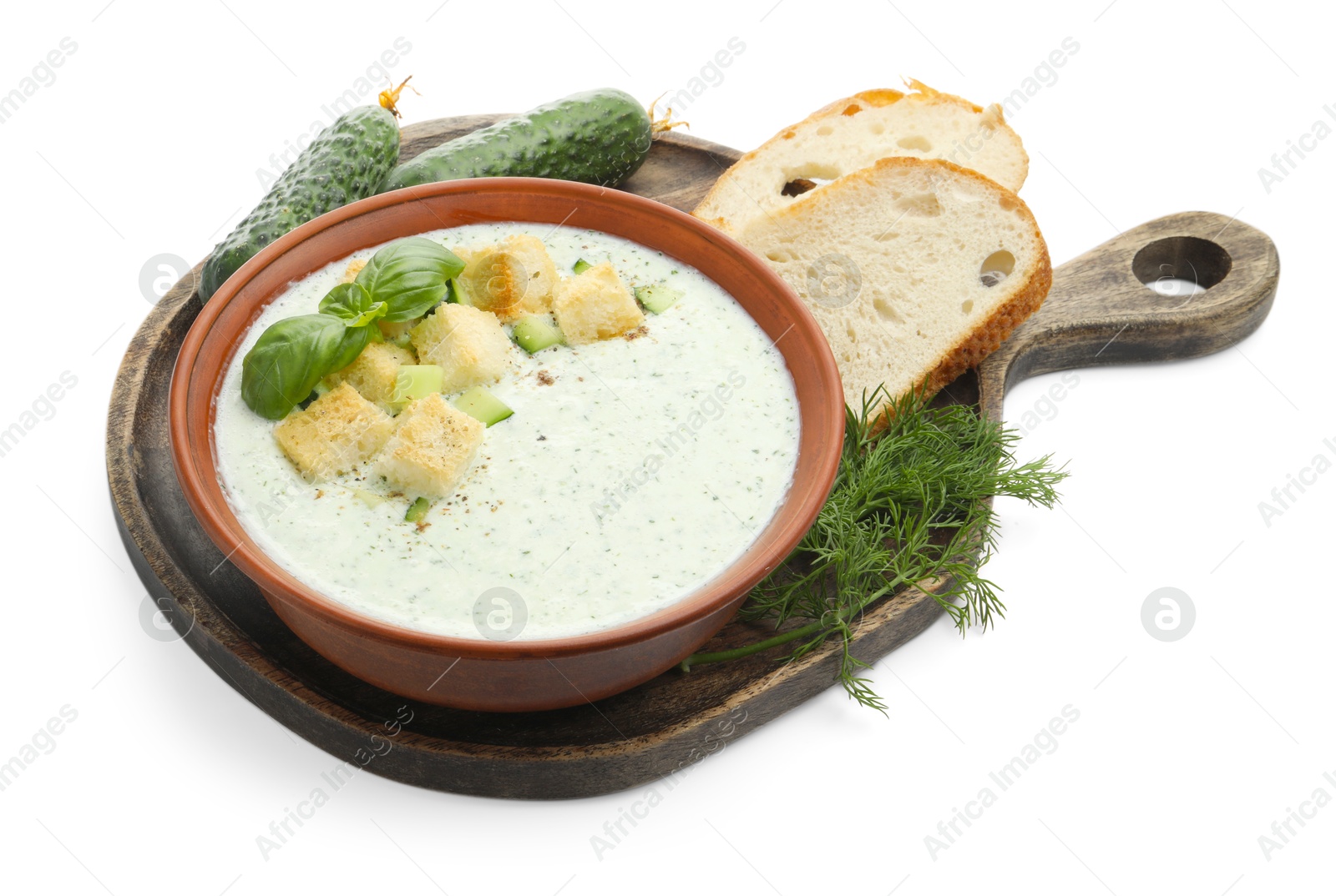 Photo of Tasty cucumber soup with croutons, basil, bread and ingredients isolated on white