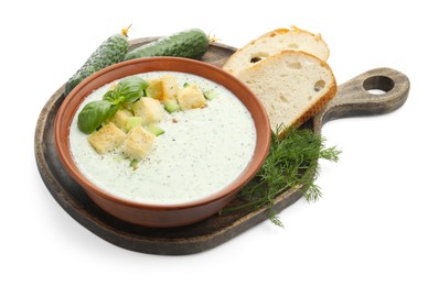 Photo of Tasty cucumber soup with croutons, basil, bread and ingredients isolated on white