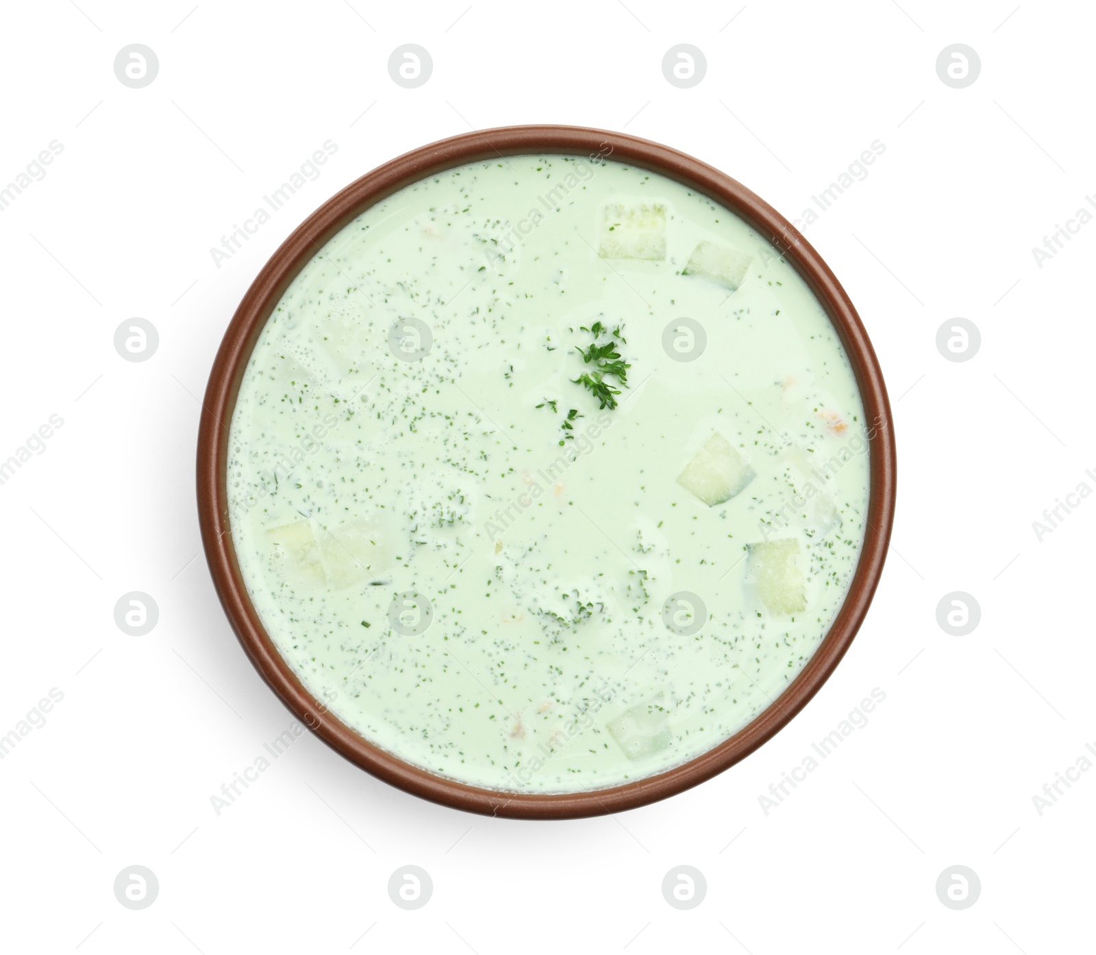Photo of Tasty cucumber soup with parsley isolated on white, top view