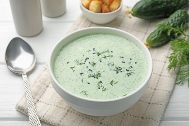 Photo of Tasty cucumber soup served on white table, closeup