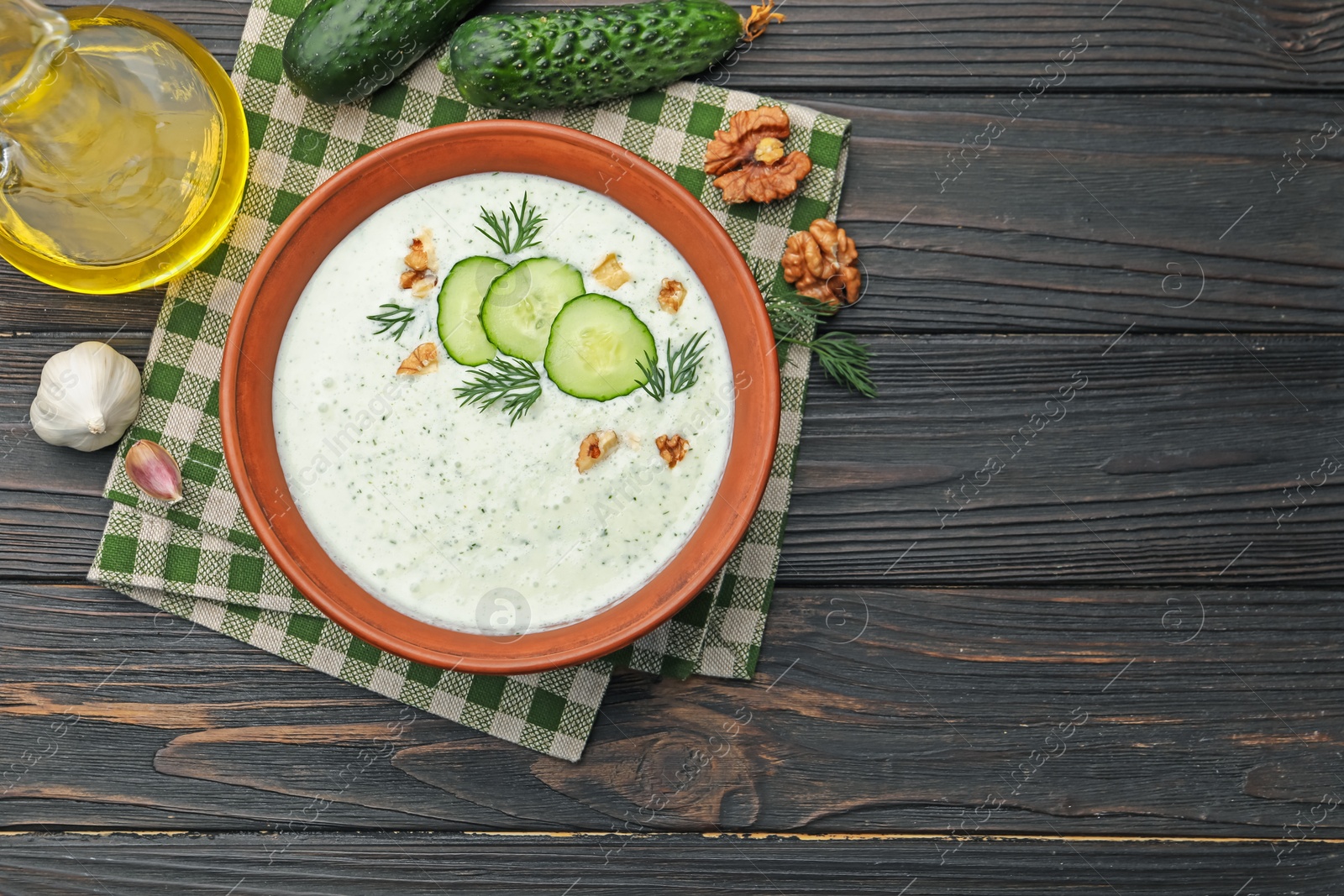 Tasty cucumber soup with dill, walnuts and ingredients on wooden table, flat lay. Space for text Photo of Tasty cucumber soup with dill, walnuts and ingredients on wooden table, flat lay. Space for text