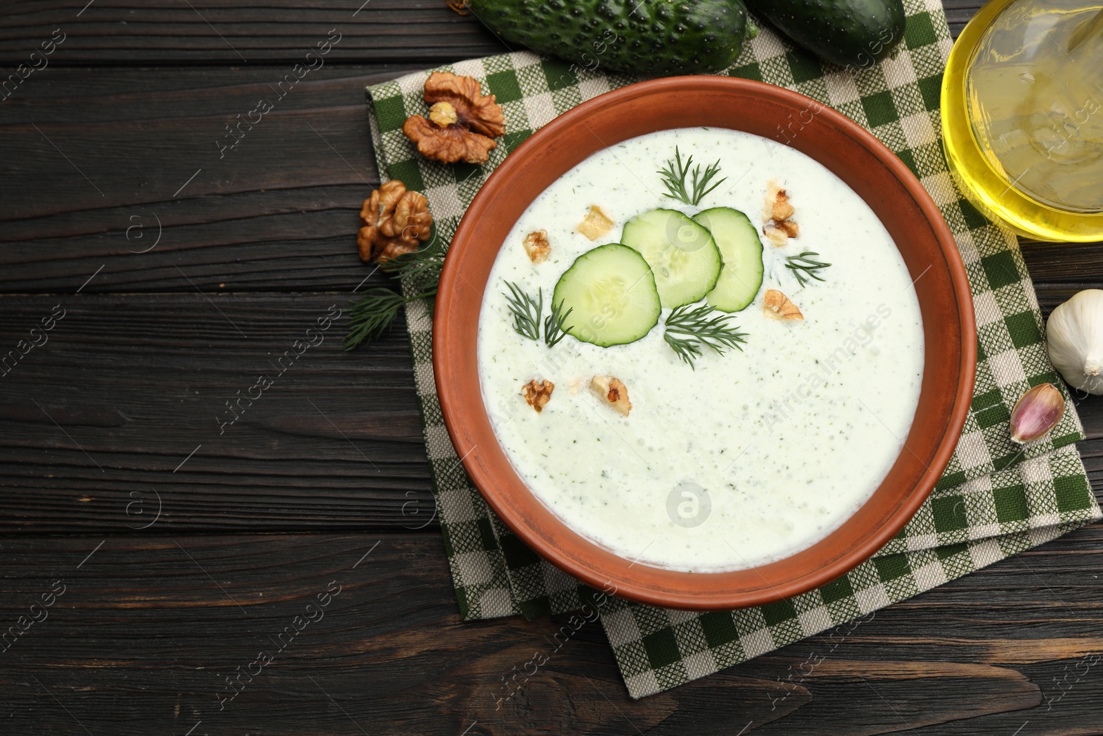 Tasty cucumber soup with dill, walnuts and ingredients on wooden table, flat lay. Space for text Photo of Tasty cucumber soup with dill, walnuts and ingredients on wooden table, flat lay. Space for text
