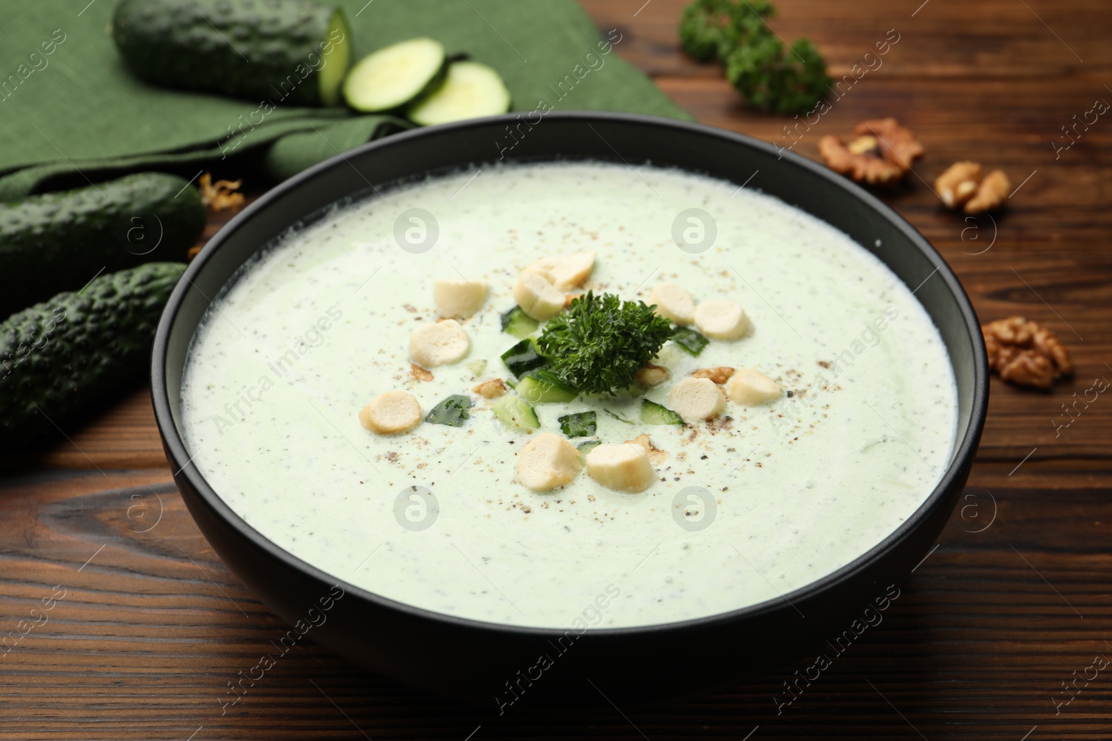 Tasty cucumber soup with croutons and broccoli on wooden table, closeup Photo of Tasty cucumber soup with croutons and broccoli on wooden table, closeup
