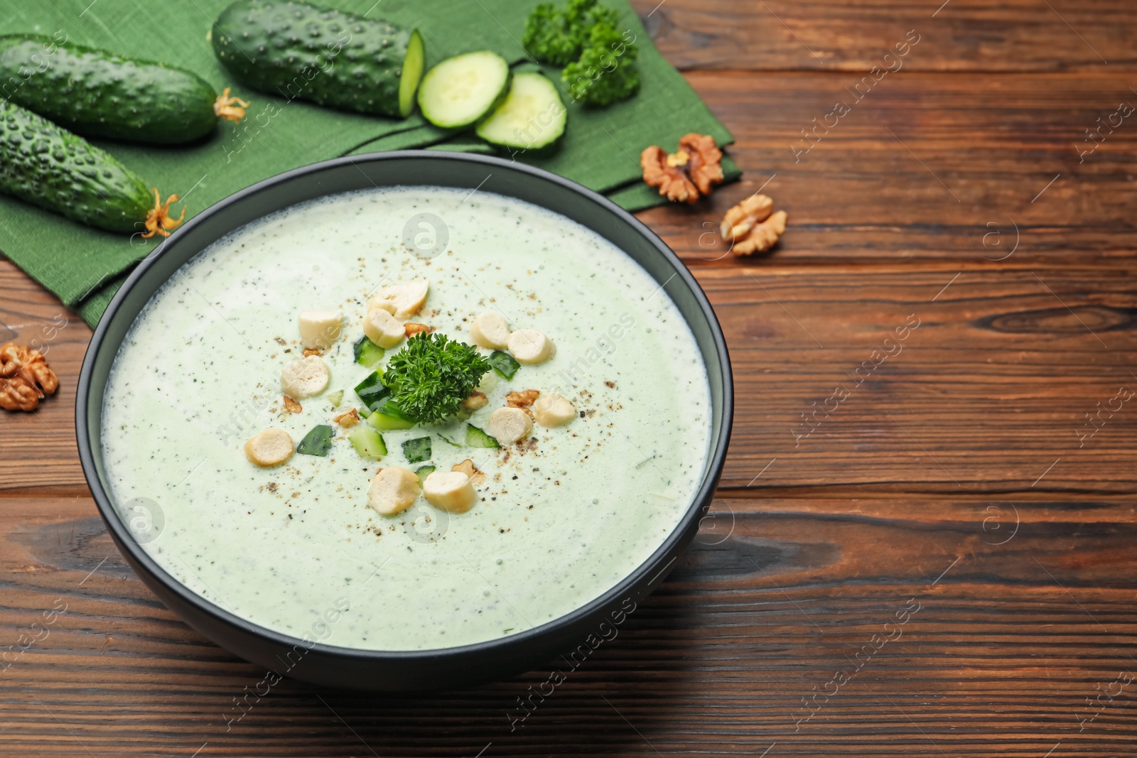 Tasty cucumber soup with croutons and broccoli on wooden table, closeup. Space for text Photo of Tasty cucumber soup with croutons and broccoli on wooden table, closeup. Space for text