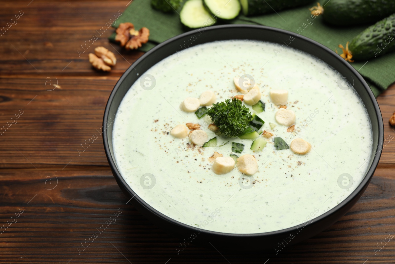 Tasty cucumber soup with croutons and broccoli on wooden table, closeup Photo of Tasty cucumber soup with croutons and broccoli on wooden table, closeup
