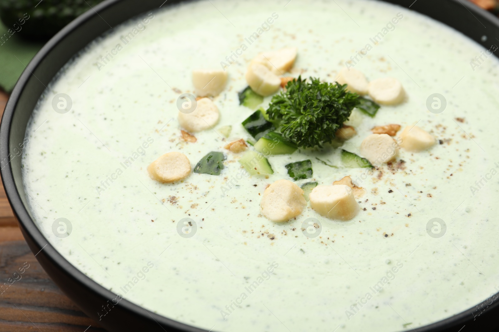 Tasty cucumber soup with croutons and broccoli on wooden table, closeup Photo of Tasty cucumber soup with croutons and broccoli on wooden table, closeup