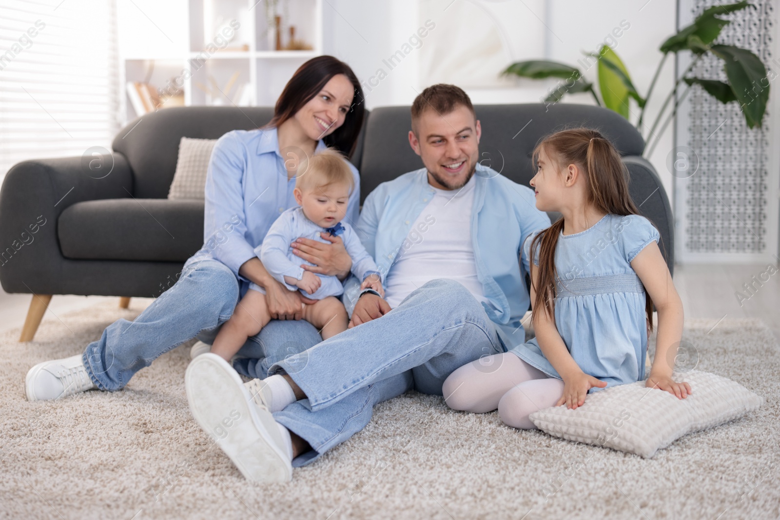 Happy parents and their kids together at home Photo of Happy parents and their kids together at home