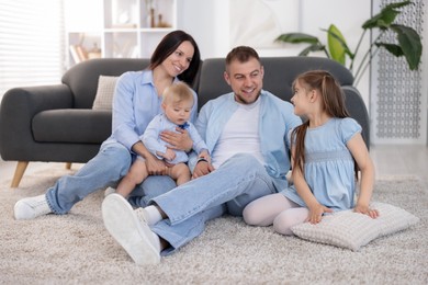 Photo of Happy parents and their kids together at home