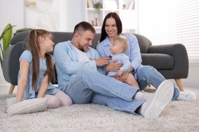 Photo of Happy parents and their kids together at home