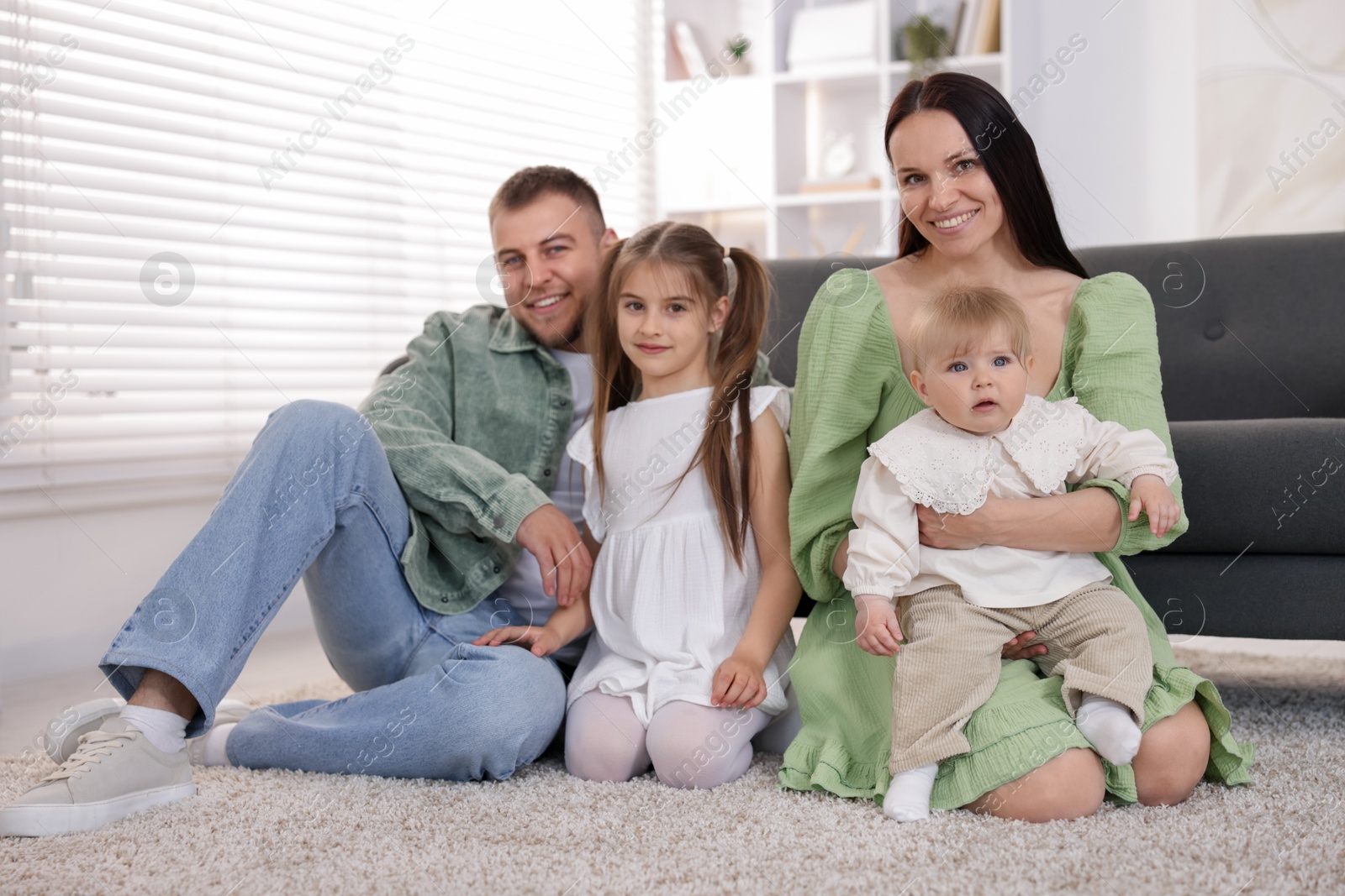 Happy parents and their kids together at home Photo of Happy parents and their kids together at home