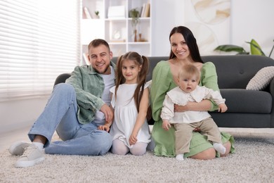 Photo of Happy parents and their kids together at home
