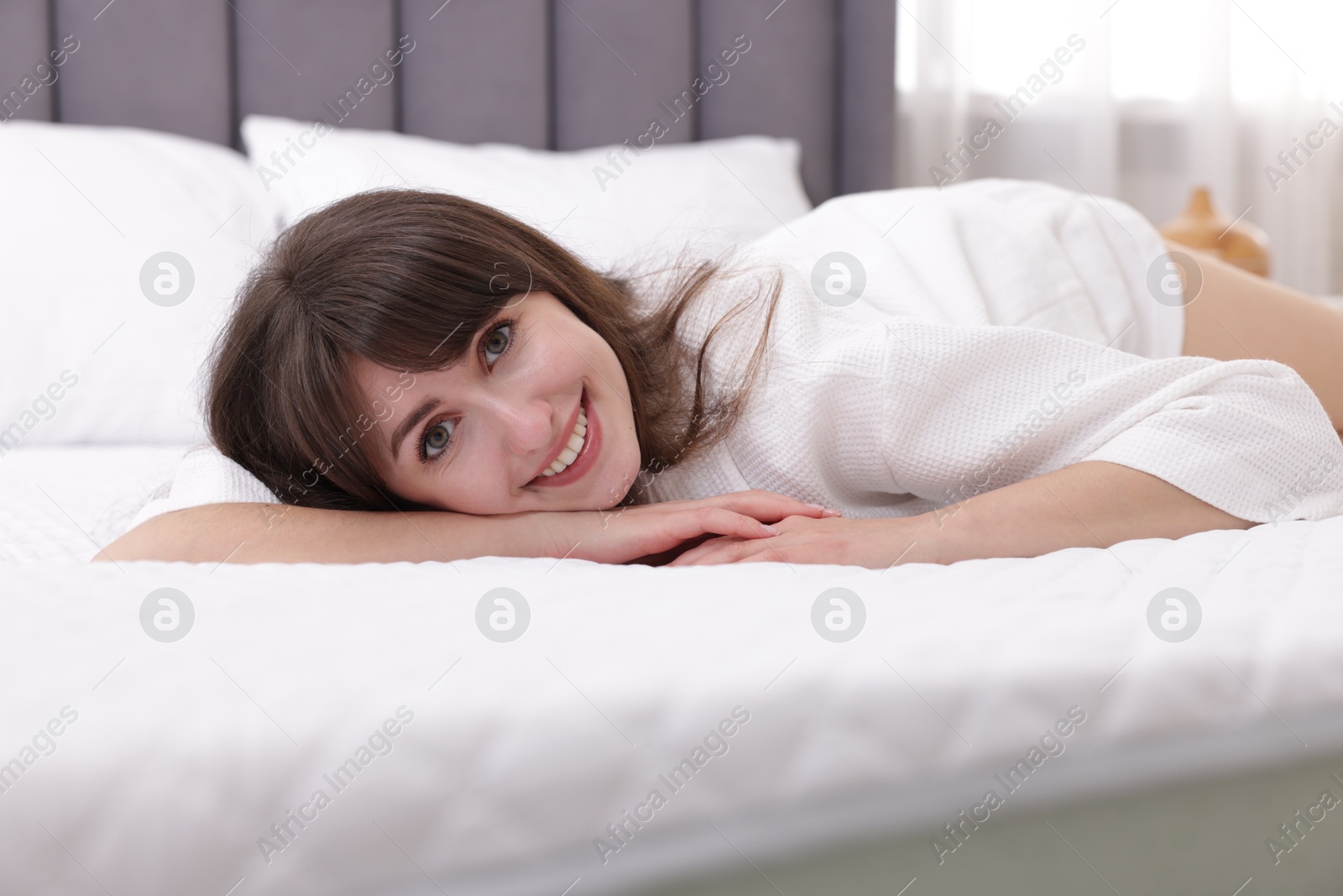 Beautiful woman lying on soft mattress at home Photo of Beautiful woman lying on soft mattress at home