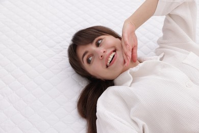 Photo of Beautiful woman lying on soft mattress at home