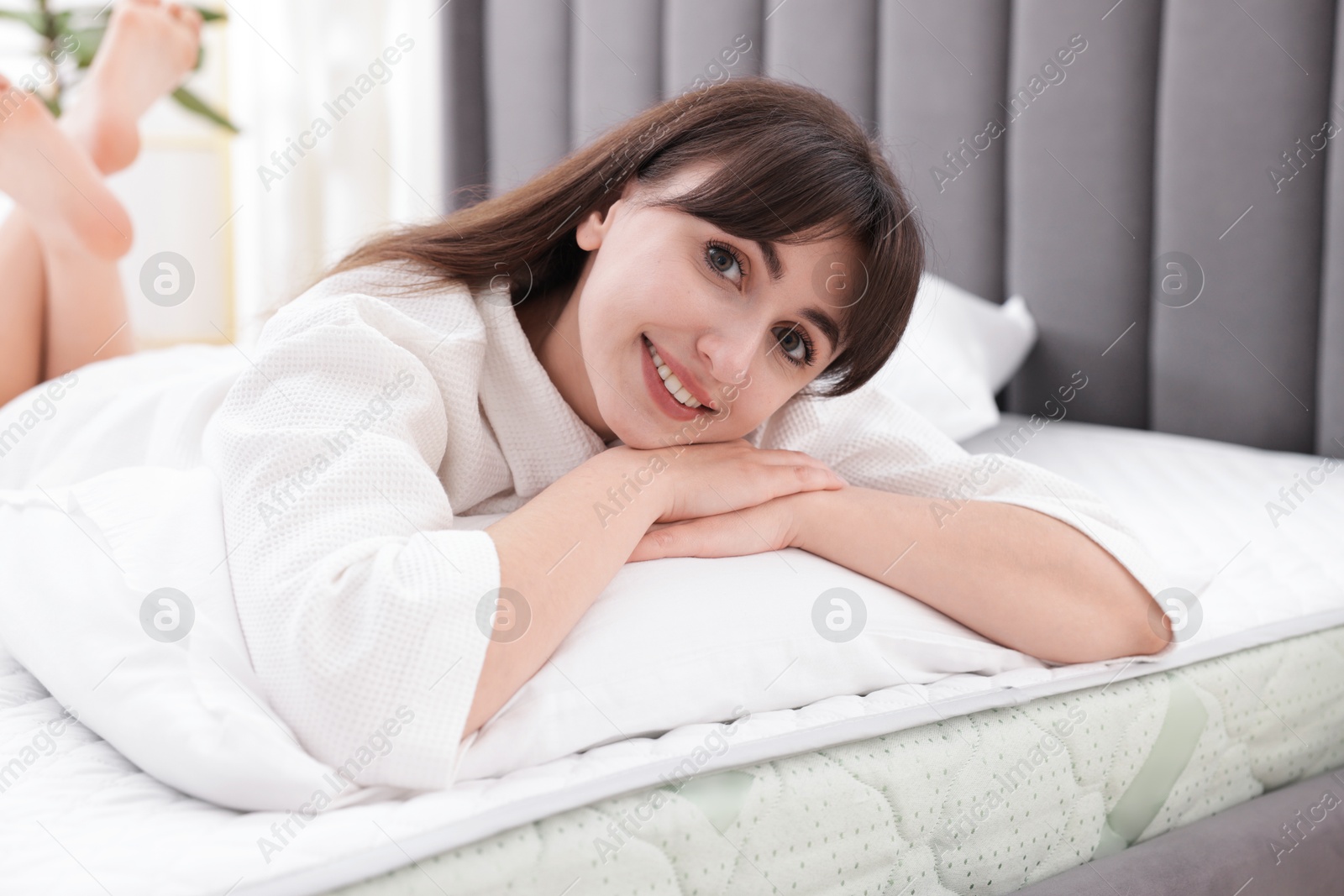 Beautiful woman lying on soft mattress at home Photo of Beautiful woman lying on soft mattress at home