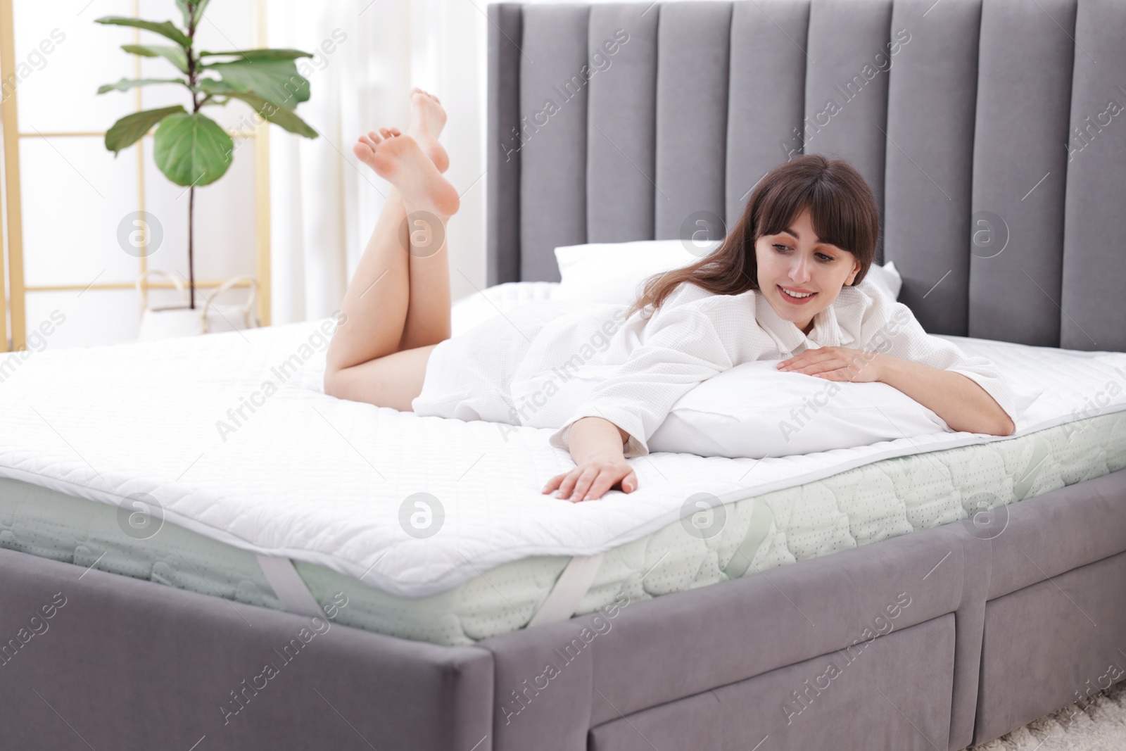 Beautiful woman lying on soft mattress at home Photo of Beautiful woman lying on soft mattress at home