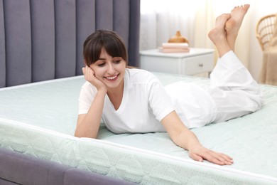 Photo of Beautiful woman lying on soft mattress at home