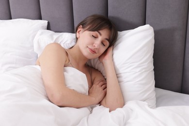 Photo of Beautiful woman sleeping in bed at home