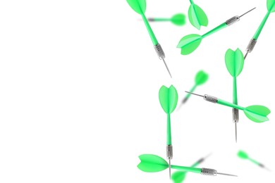 Image of Green darts in air on white background