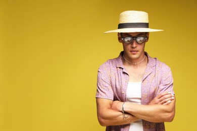 Photo of Fashionable portrait of handsome man in stylish outfit on color background, space for text