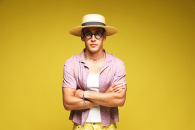 Photo of Fashionable portrait of handsome man in stylish outfit on color background