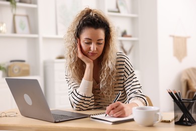Photo of Woman working at desk in home office