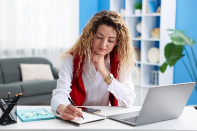 Photo of Woman working at desk in home office