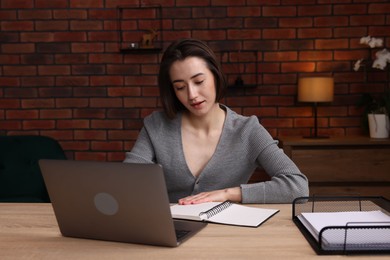 Photo of Woman working at desk in home office