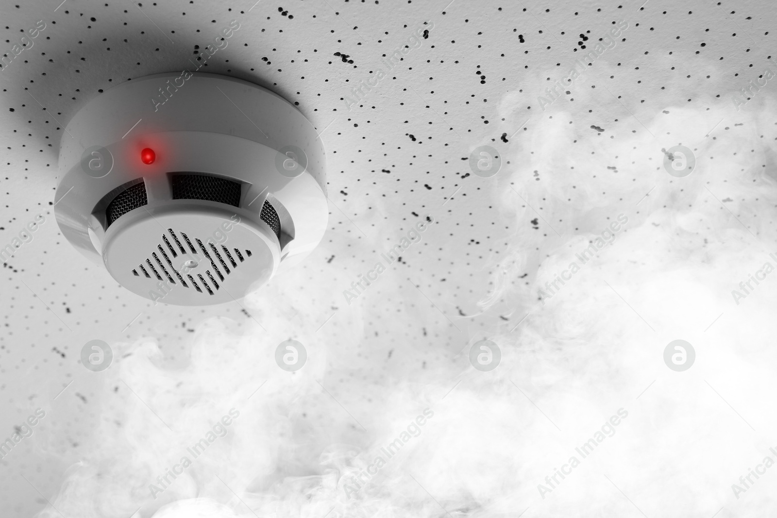 Fire alarm system. Detector on ceiling triggered by smoke Image of Fire alarm system. Detector on ceiling triggered by smoke